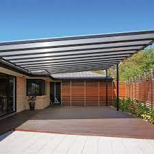 13M X 10M CARPORT PANAROMIC POLYCAD ROOFING( BLACK / GREY SHEETS). STEEL FRAME, SPRAY PAINTED WITH BRONZE ENAMEL